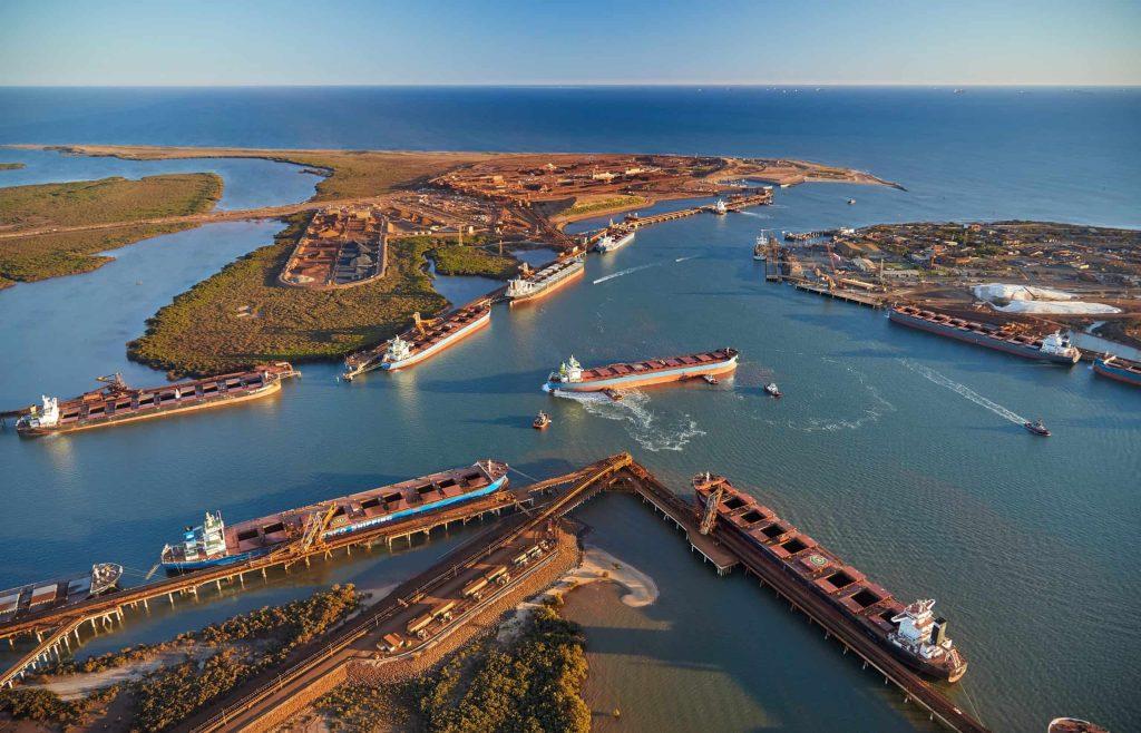 Aerial view of Port Hedland harbour with iron ore carriers at berth and ship loaders on the wharves