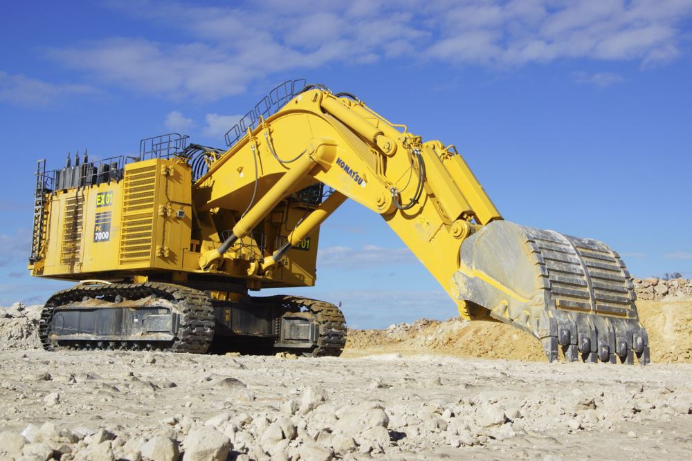 Plant operator and site crew working alongside an excavator on an Australian resources project