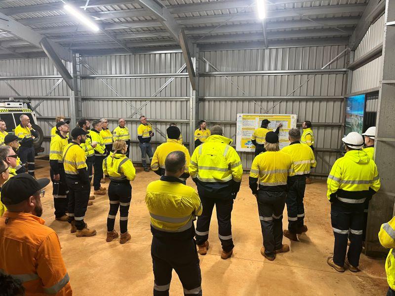 Site crew in PPE at a toolbox briefing on a Western Australian mining project